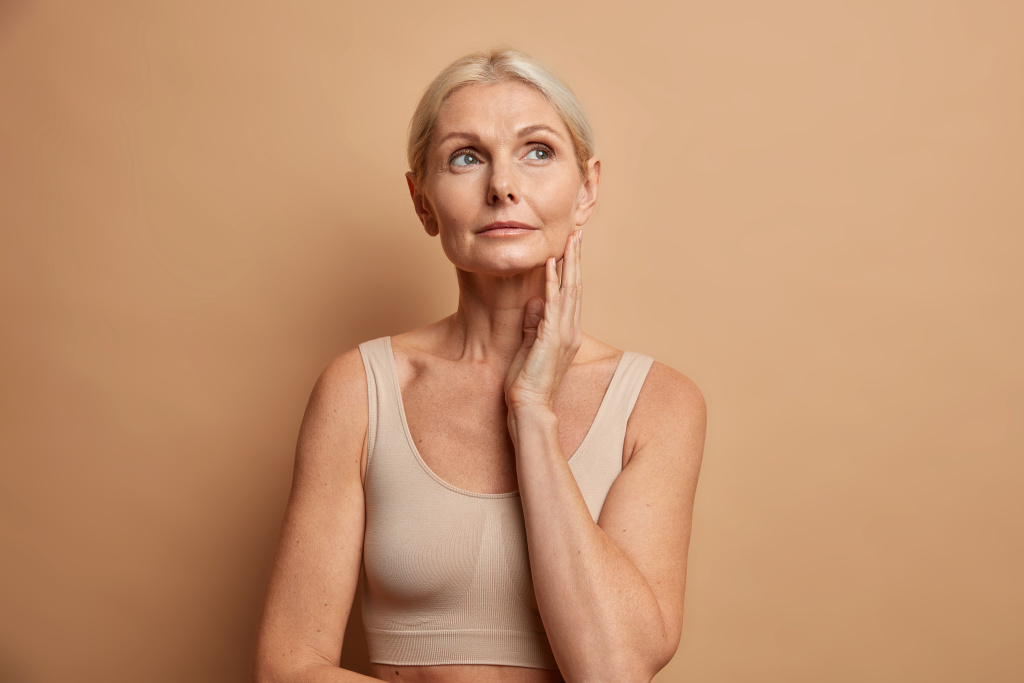 woman-touches-skin-after-applying-anti-age-cream-concentrated-with-thoughtful-expression-wears-cropped-top-isolated-brown.jpg woman-touches-skin-after-applying-anti-age-cream-concentrated-with-thoughtful-expression-wears-cropped-top-isolated-brown.jpg